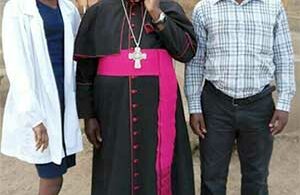 Some of the Health Centre’s staff Nandugga Agnes (L) and Ochieng Benard (R) pose for a photo with the Rt. Rev. Bishop John Baptist Kaggwa, former Bishop of Masaka Diocese during his pastoral visit to Namabaale Parish on 15th November 2017