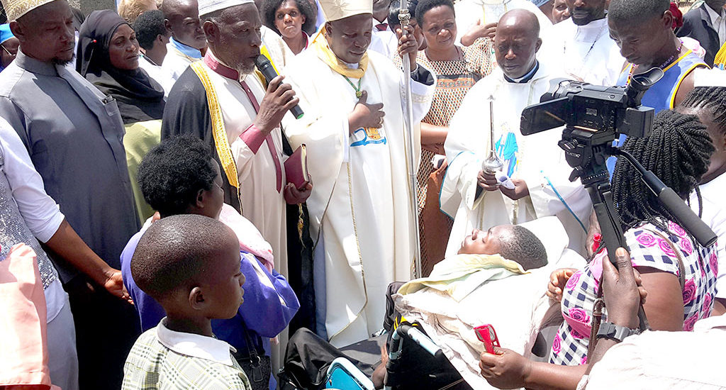 Bishop Serverus Jjumba with Lyantonde District Khadd praying for the sick