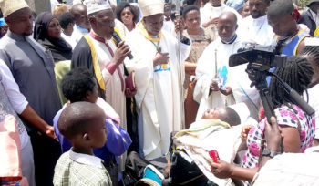 Bishop Serverus Jjumba with Lyantonde District Khadd praying for the sick